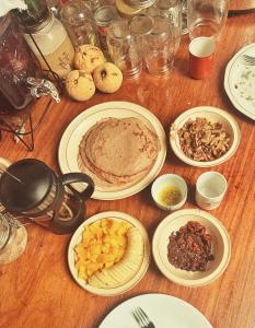 a wooden table with plates of food on it at The Village Eco-Bungalows in Salvacion, Busuanga in Busuanga