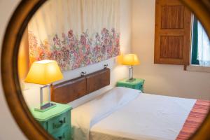 a bedroom with a bed and two night stands with lamps at Mar de Serra in Rio Maior