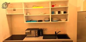 a kitchen with a sink and a coffee maker at Stylish Homes Downtown Buda in Budapest