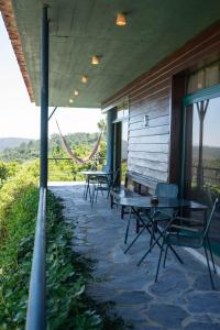 a patio with tables and chairs on a house at Mar de Serra in Rio Maior