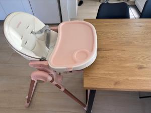 a pink chair sitting next to a wooden table at Apartment Lucija in Šimuni