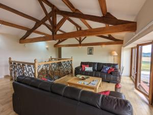 a living room with a couch and a table at Grange des Bardins in Villebois-Lavalette