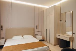 a bedroom with a large bed and a sink at Asad in Astana