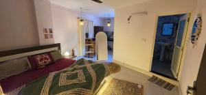 a bedroom with a bed and a door to a hallway at SAMANI Homestay in Rishīkesh