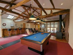 a living room with a pool table in it at Grange des Bardins in Villebois-Lavalette
