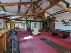 a room with a pool table and some chairs at Grange des Bardins in Villebois-Lavalette +62 photos
