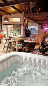 a large pool of water in a room with a table at LARCADE Loft Industrial in Castillo de Bayuela