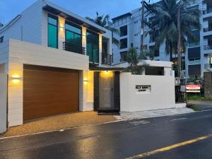 a house with a garage and a building at Villa Maria Luxury in Kamala Beach