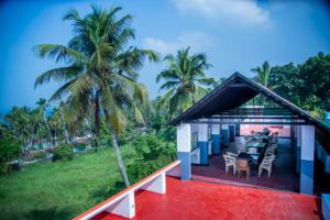 a balcony of a house with a table and chairs at Ocean Queen Palace Kovalam in Trivandrum