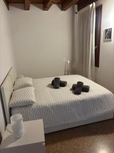 a bedroom with a bed with two black pillows on it at la promenade in Vicenza
