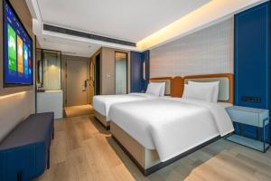 Postel nebo postele na pokoji v ubytování Huanman Hotel Hengyang Jiefang Road Lianhu Square Branch