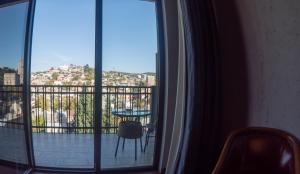 a room with a window with a view of a balcony at TM Apart Hotel in Tbilisi City