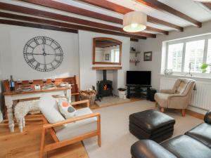 a living room with a fireplace and a clock on the wall at Daleholme in Barnard Castle