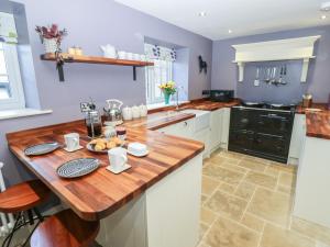 a kitchen with a wooden counter top in a kitchen at Daleholme in Barnard Castle