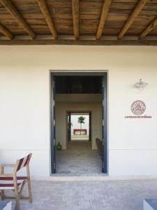 an open doorway to a patio with a wooden ceiling at Capricho de Doñana in El Rocío +135 photos