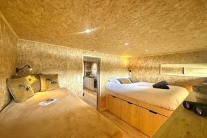 a bedroom with two beds in a room at Les 1000 Ailes-Expérience Unique dans une Hutte in Le Crotoy