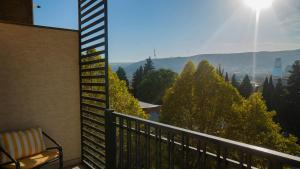 a balcony with a view of the mountains at TM Apart Hotel in Tbilisi City
