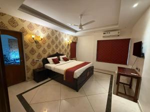 a bedroom with a bed and a television in it at Queens Homestay in Trivandrum