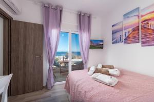 a bedroom with a bed with a pink bedspread at Gennadi Villa Mary in Gennadi +50 photos