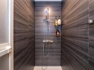 ひとあかり 東山 Hitoakari Higashiyama-A Warm and Modern Machiya Stay في Shimmachidōri: دش في حمام بجدران خشبية +152 صورة