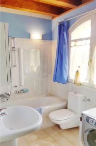 a bathroom with a toilet and a tub and a sink at Borgo del Torchio H3 ByBookinggardalake in Manerba del Garda