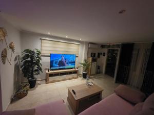 a living room with a flat screen tv and a couch at Loft paradisse in Melilla