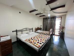 a bedroom with a bed with a blanket on it at 3BHKVilla Panshet in Lavasa