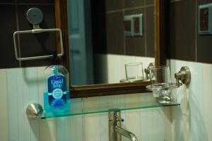 a bottle of soap on a glass shelf in a bathroom at Ripple Beach Inn in Hulhumale +180 photos