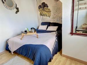 a bedroom with a bed with a table on it at Escale en bord de mer T3 au coeur de Saint-Quay in Saint-Quay-Portrieux