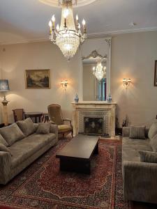 a living room with a couch and a fireplace at Demeure 13 Personnes Au Centre Ville De Ruffec in Ruffec