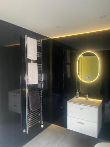 a bathroom with a sink and a mirror at Crowtree Lodge in Louth +13 photos