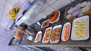 a counter top with plates of food on it at Becker Center Hotel in Querencia