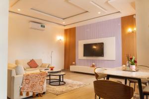 a living room with a couch and a table at ResidHome A&M in Abomey-Calavi