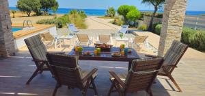 a patio with a table and chairs and the ocean at Gennadi Villa Mary in Gennadi