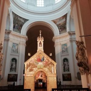 a large room with a church with paintings on the walls at Assisi - Appartamento Maristella in Santa Maria degli Angeli