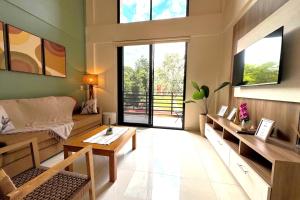 a living room with a couch and a table at Iguazu Lofts in Puerto Iguazú