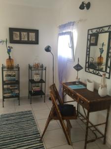 a room with a desk and a chair and a lamp at Apartment Gigi in Jadranovo