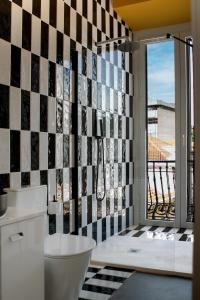 uma casa de banho com uma parede em azulejo preto e branco em Glória Suites Hotel em Lisboa