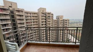 a balcony with a view of apartment buildings at Krishna Heights in Karnal