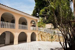a large house with a balcony on top of it at Casarão José Morada in Belo Horizonte