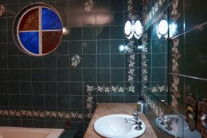 a bathroom with a sink and a mirror at Casarão José Morada in Belo Horizonte +83 photos