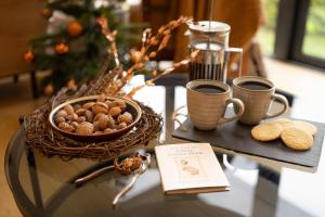 a table with two cups of coffee and a basket of nuts at Beautiful Luxury one bedroom retreat in Far Sawrey in Far Sawrey