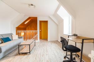 a living room with a couch and a table at Maison Confortable au coeur de Guingamp in Guingamp