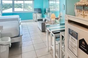 uma sala de estar com uma mesa e um sofá em Top of the Gulf 810 em Panama City Beach