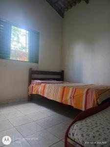 Ένα ή περισσότερα κρεβάτια σε δωμάτιο στο Casa temporada em Cavalcante +1 φωτογραφίες