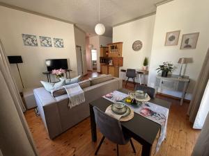 a living room with a couch and a table at Swellengrebel Nest in Swellendam