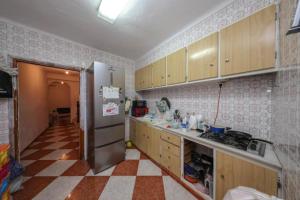 a kitchen with a refrigerator and a checkered floor at Tropical Elegance in central Panglao ! in Panglao +2 photos