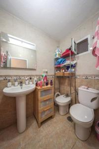 a bathroom with a sink and a toilet and a mirror at Tropical Elegance in central Panglao ! in Panglao