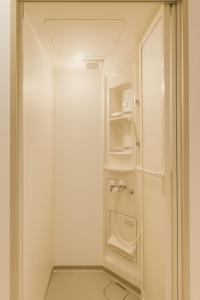 a small bathroom with a washer and dryer at Yellow House Niseko in Kutchan