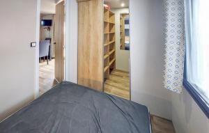 a room with a bed and a hallway at Nice Stacaravan In Saint-Julien-En-Born in Saint-Julien-en-Born